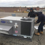 Exallan crew working on a Carrier commercial air conditioning unit